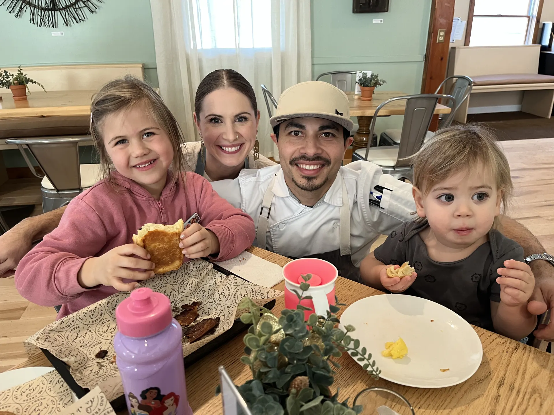 The Calderon family sharing breakfast at a table in Alder's dining room