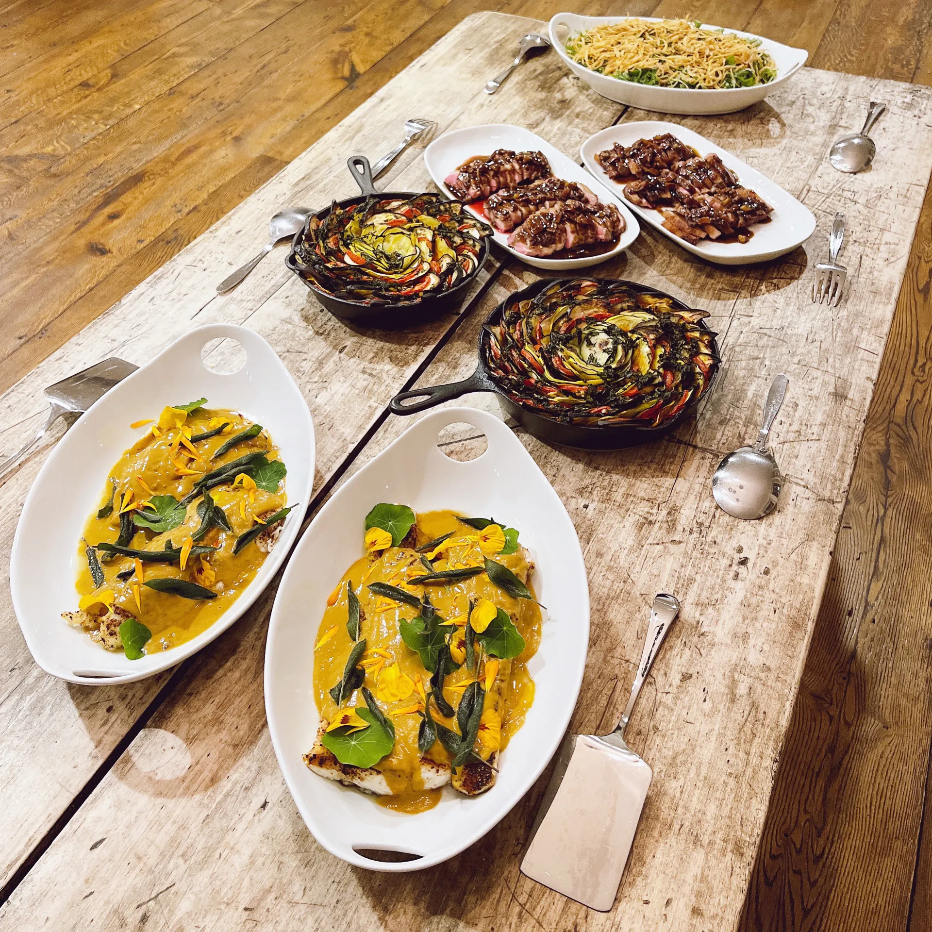 Catering platters laid out along a rustic wooden table
