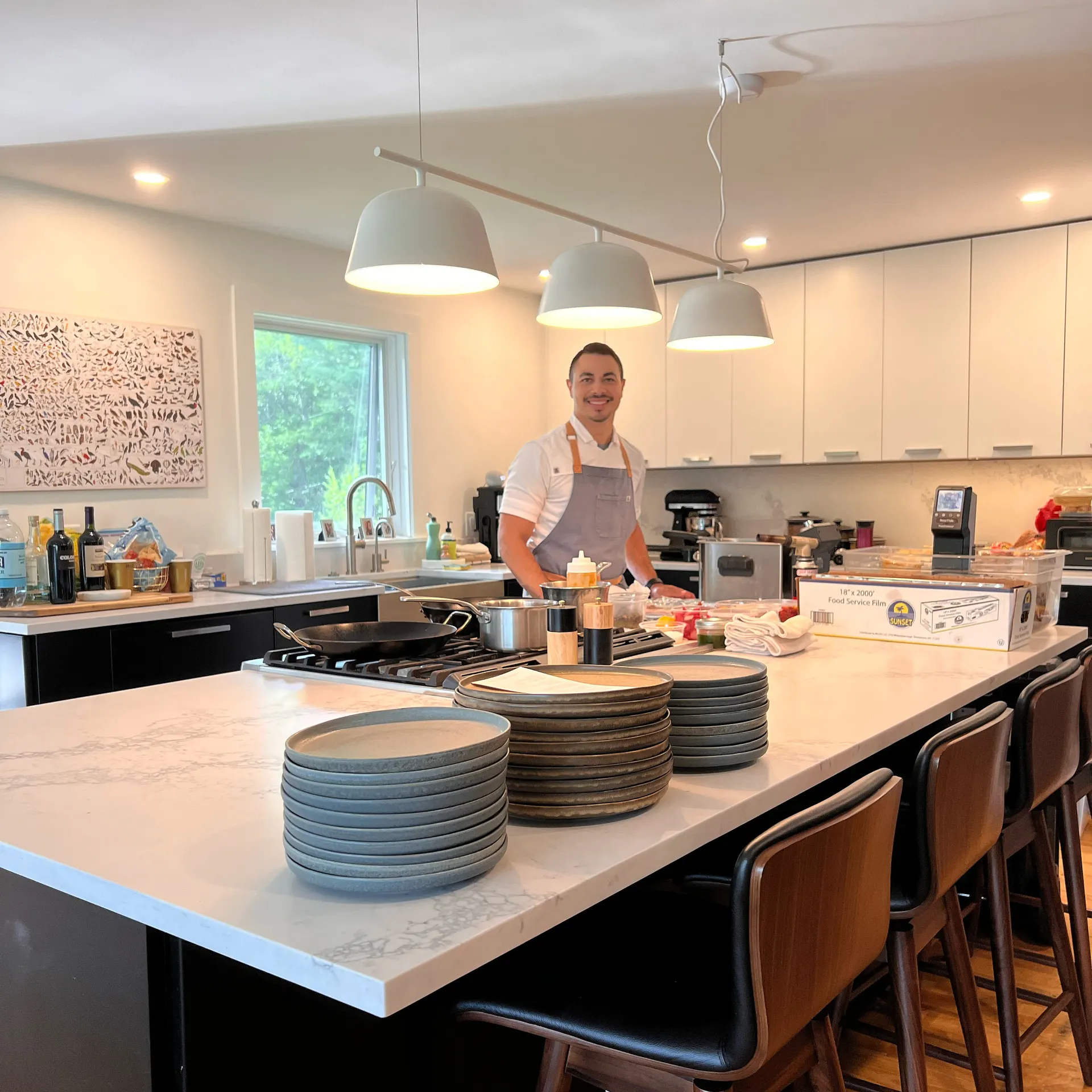 Chef Miguel Calderon plating a private dinner in a client's kitchen