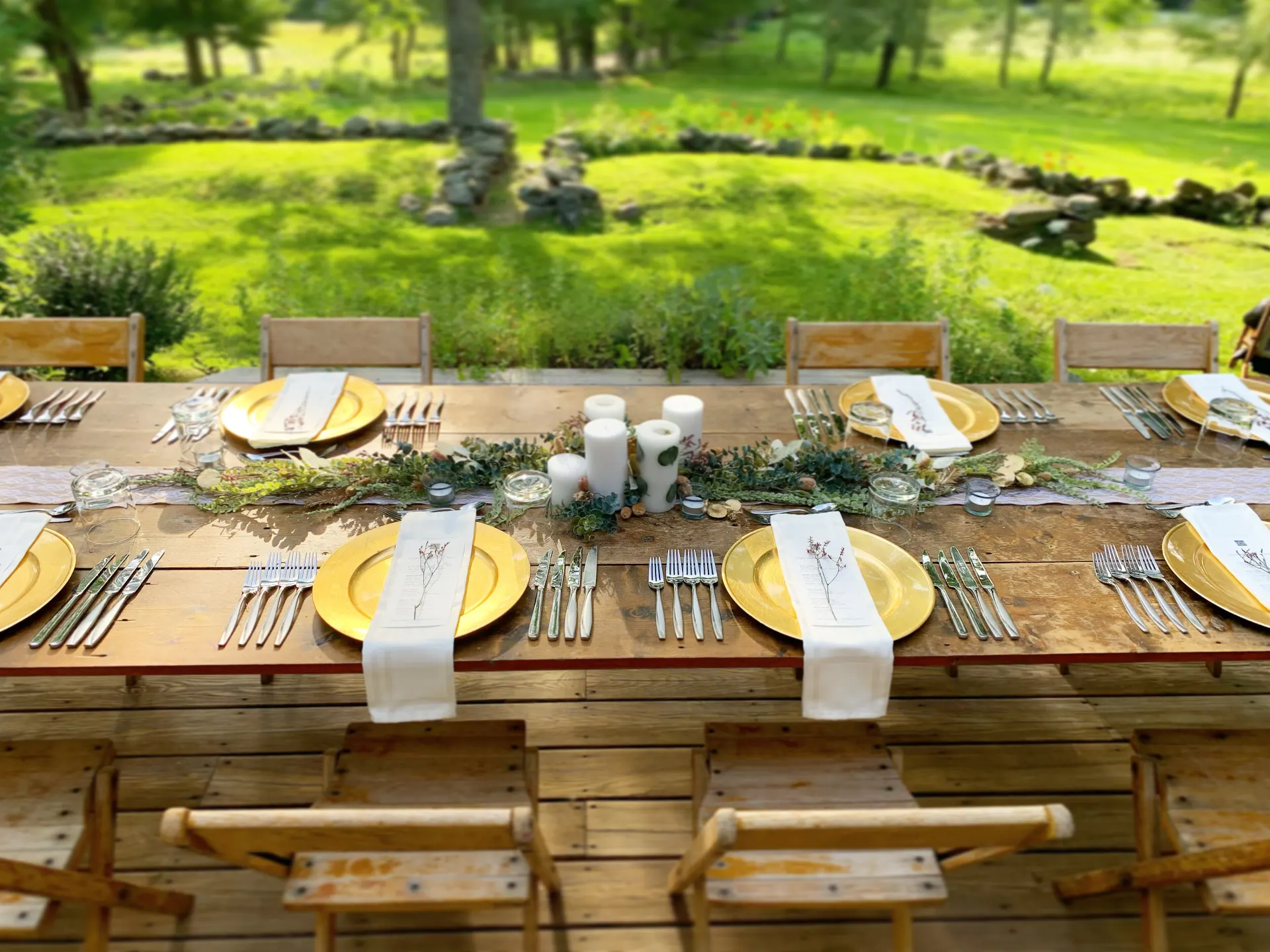 A long table set for dinner on a lawn